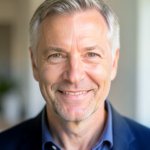 A middle-aged Caucasian man is looking towards the camera with a friendly expression.